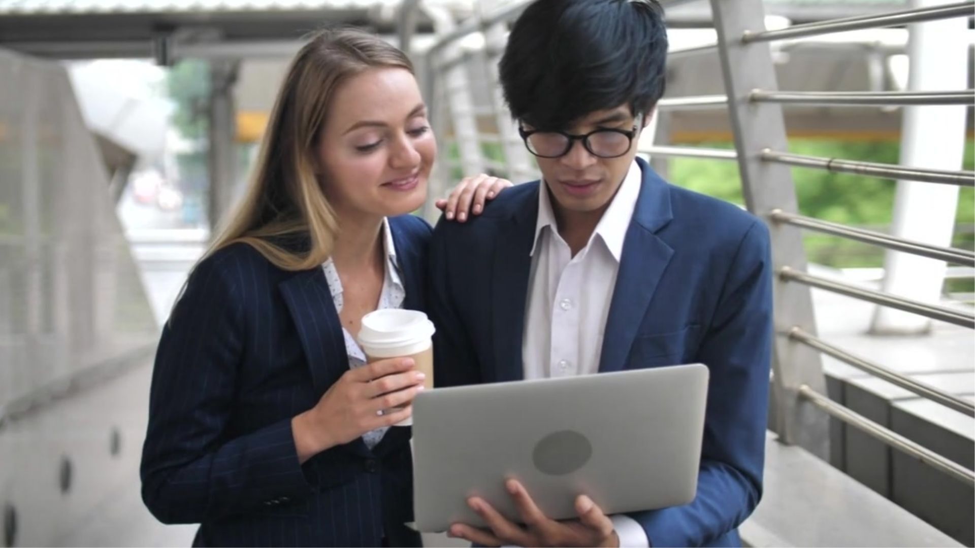 Young professionals reviewing learning information on a laptop.
