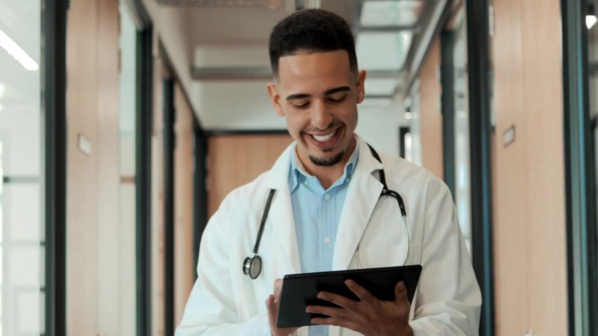 Team member working on a tablet in a professional workplace setting.