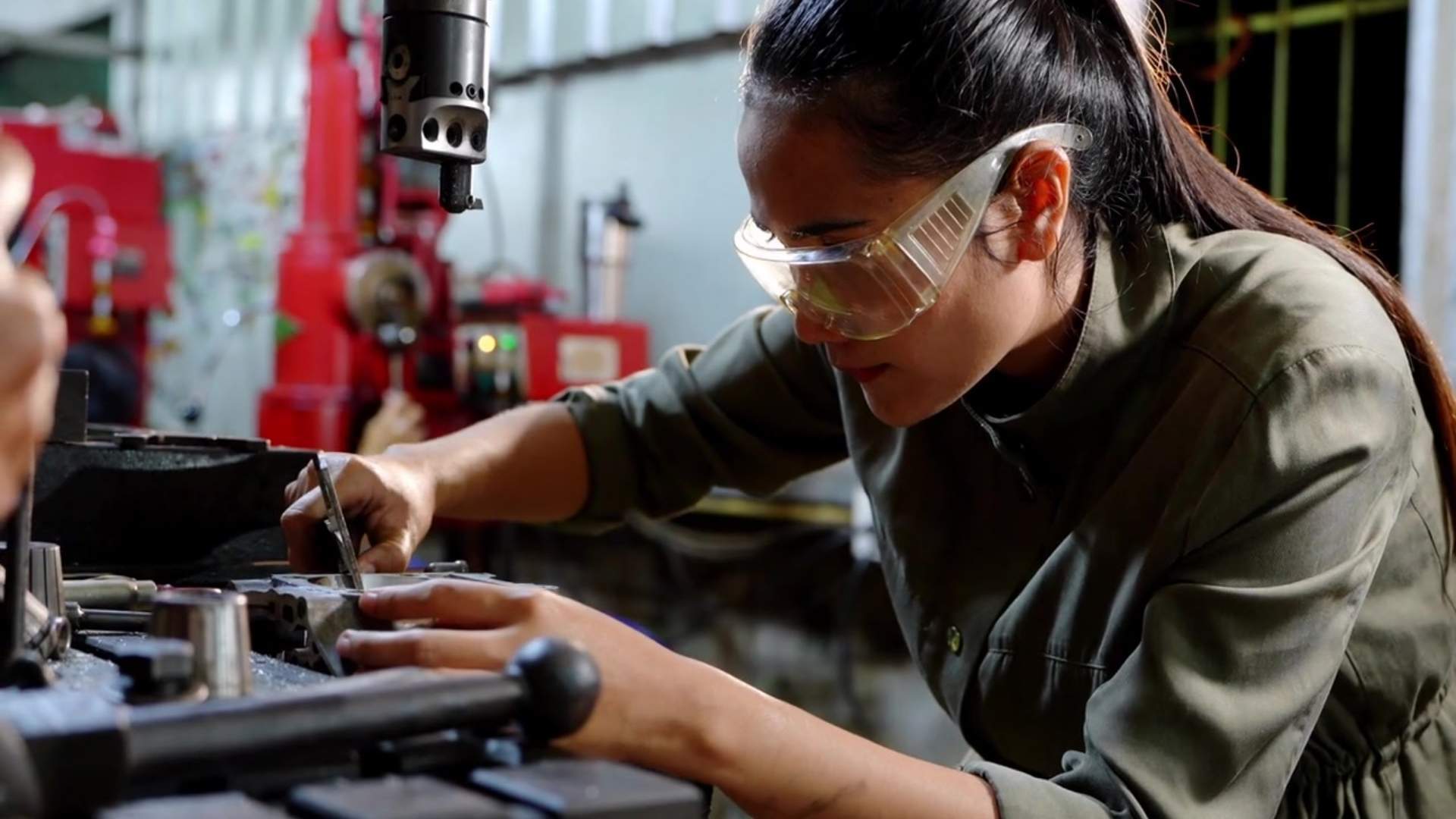 Worker performing technical work on machinery.